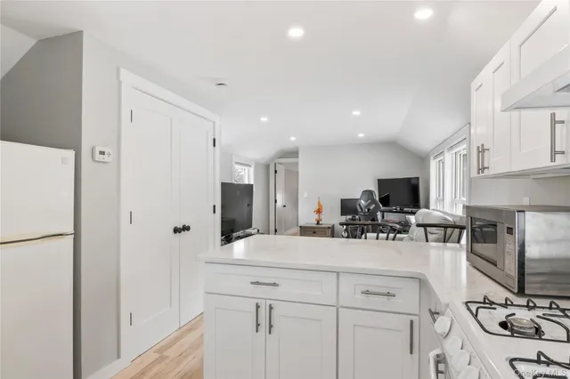 a kitchen with a sink appliances and cabinets