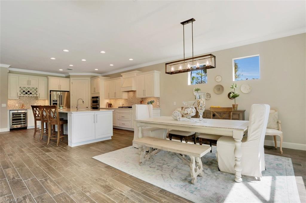 7005 Live Oak Drive Naples, FL 34114 - Photo 11 of 24 a living room with furniture a dining table with kitchen view