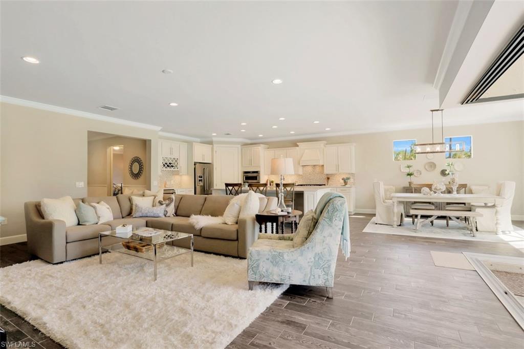 7005 Live Oak Drive Naples, FL 34114 - Photo 13 of 24 a living room with furniture and a table