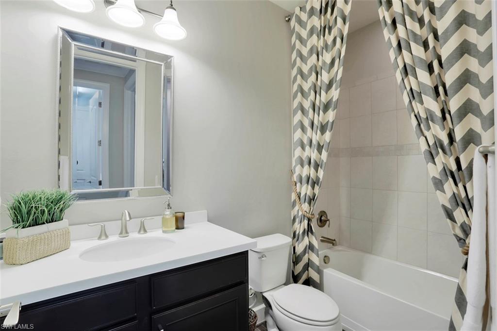 7005 Live Oak Drive Naples, FL 34114 - Photo 17 of 24 a bathroom with a sink toilet and shower