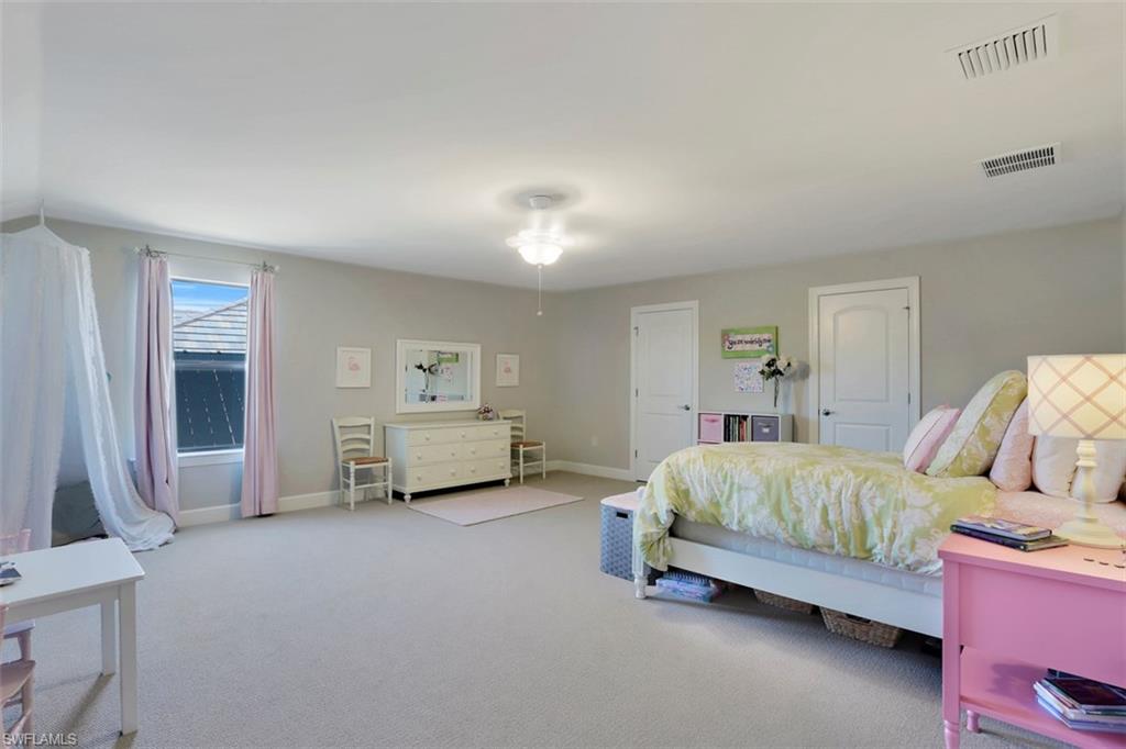 7005 Live Oak Drive Naples, FL 34114 - Photo 19 of 24 a bedroom with a bed and a couch