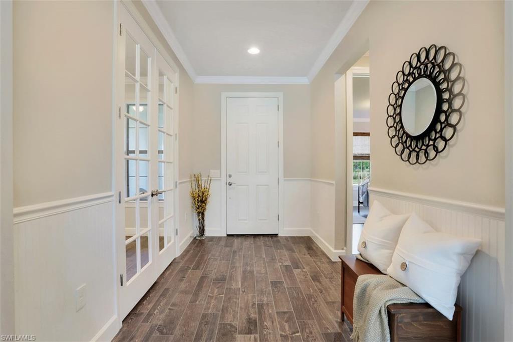 7005 Live Oak Drive Naples, FL 34114 - Photo 2 of 24 a view of a hallway with wooden floor and entryway