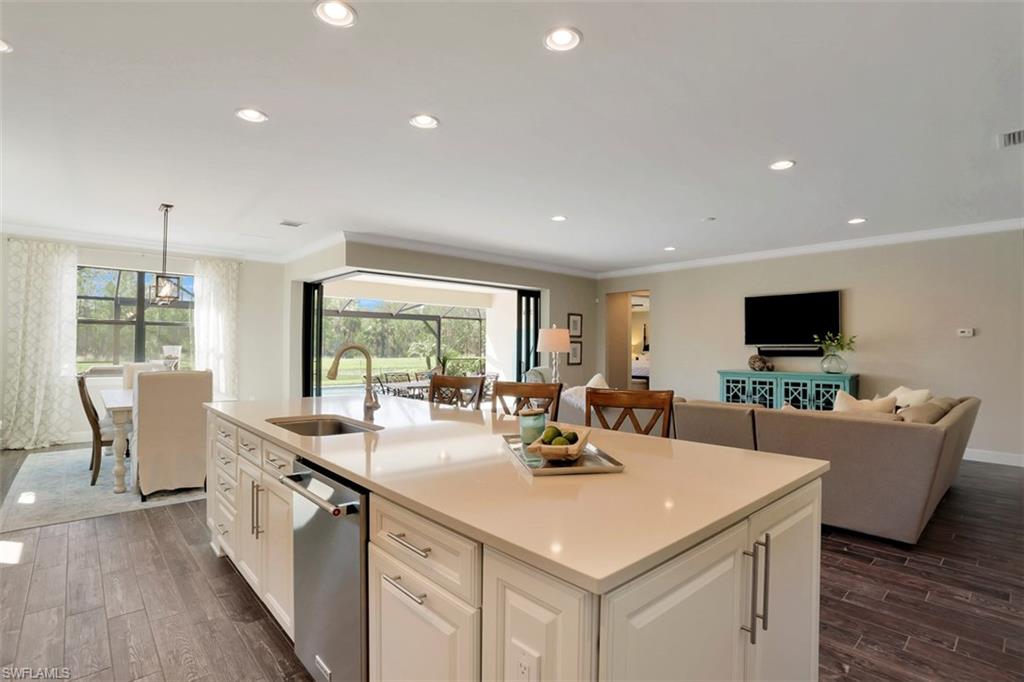 7005 Live Oak Drive Naples, FL 34114 - Photo 9 of 24 a large white kitchen with a large window and stainless steel appliances
