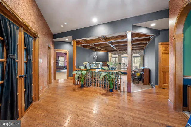 a living room with furniture a flat screen tv and a large window