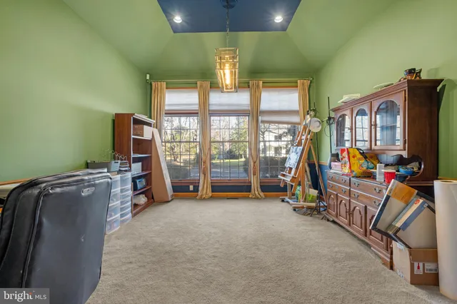 an empty room with furniture and a flat screen tv