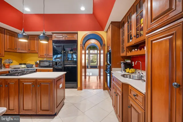 a kitchen with stainless steel appliances granite countertop a sink and cabinets