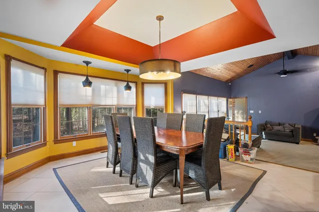 a living room with furniture a fireplace and a large window