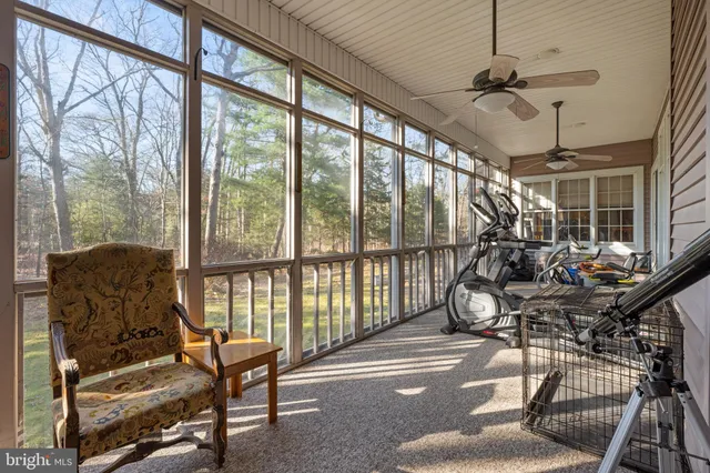 a front view of a house with a big yard and potted plants