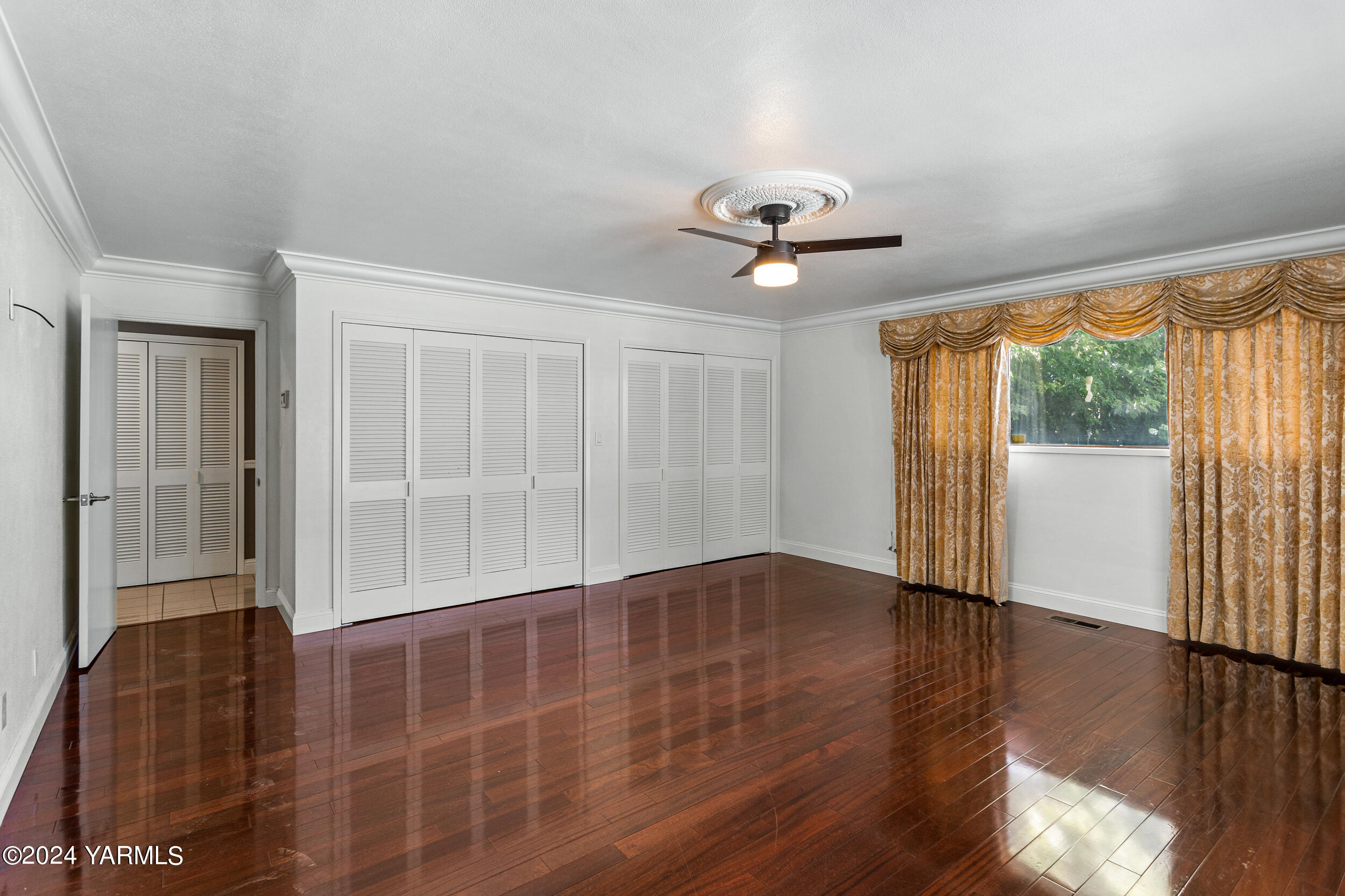 531 McDonald Road Toppenish, WA 98948 - Photo 30 of 78 a view of an empty room with a window and wooden floor
