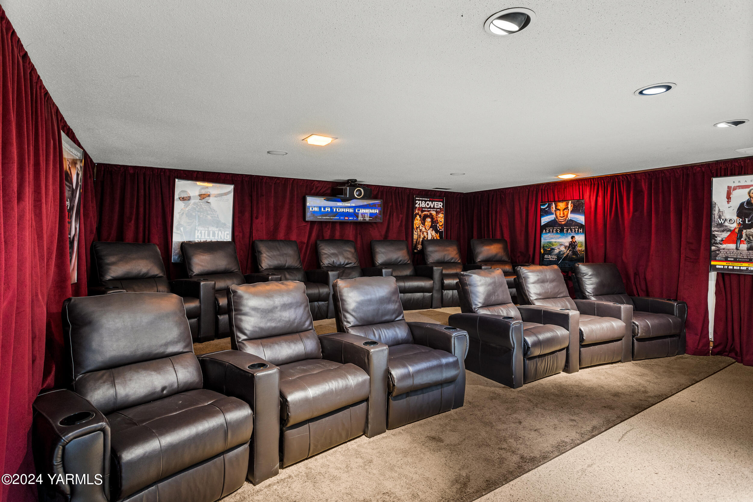 531 McDonald Road Toppenish, WA 98948 - Photo 38 of 78 a media room with lots of chairs and a projector screen