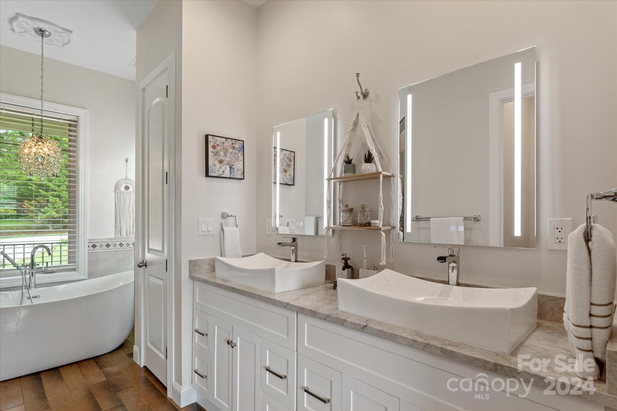464 Hooper Creek Road Tryon, NC 28782 - Photo 11 of 24 a bathroom with a double vanity sink a mirror and a bathtub