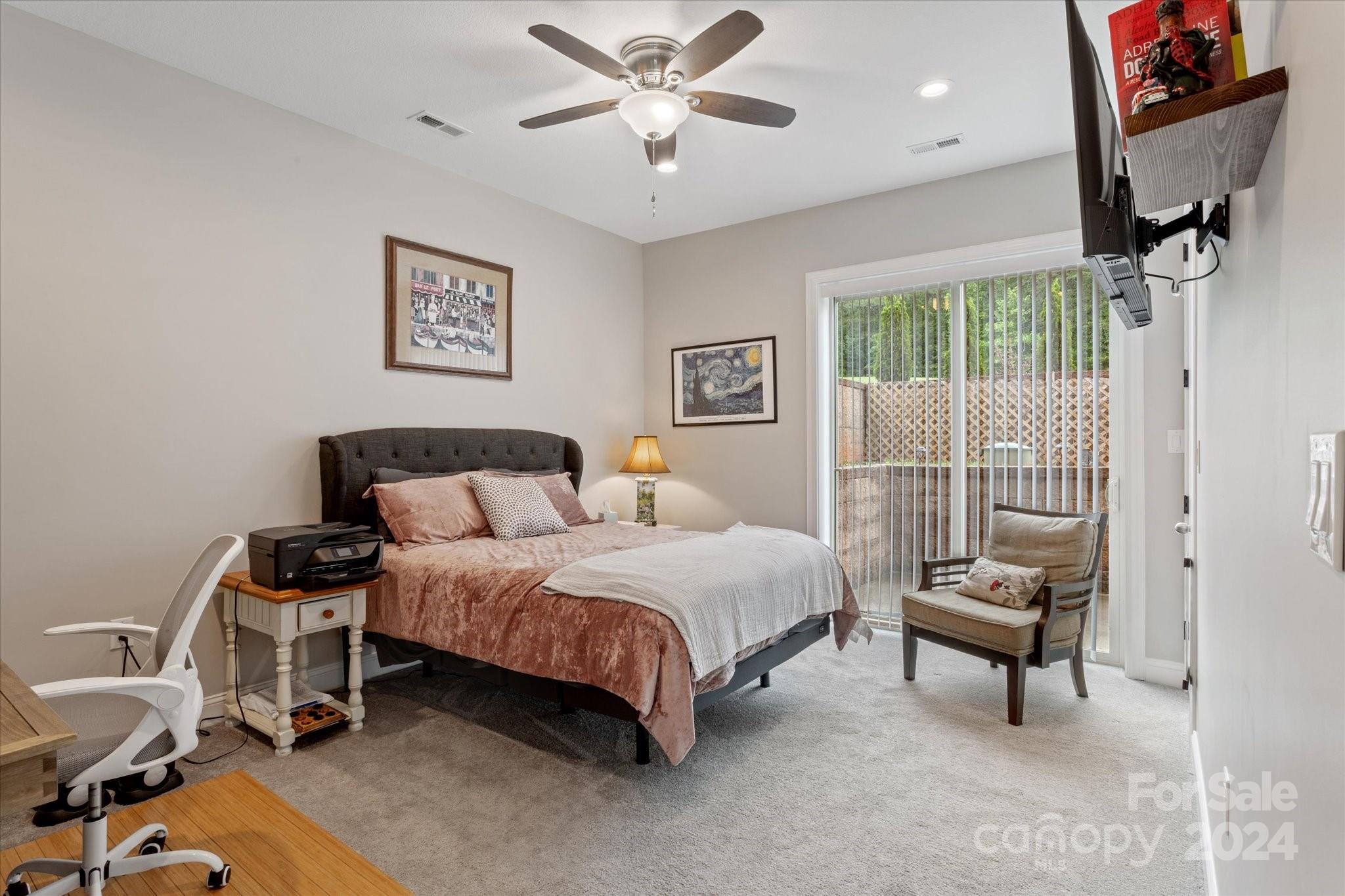 464 Hooper Creek Road Tryon, NC 28782 - Photo 15 of 24 a bedroom with a bed and a chandelier