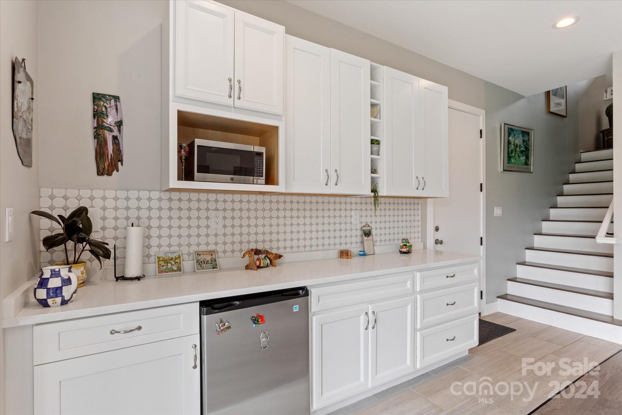 464 Hooper Creek Road Tryon, NC 28782 - Photo 16 of 24 a kitchen with white cabinets and white appliances