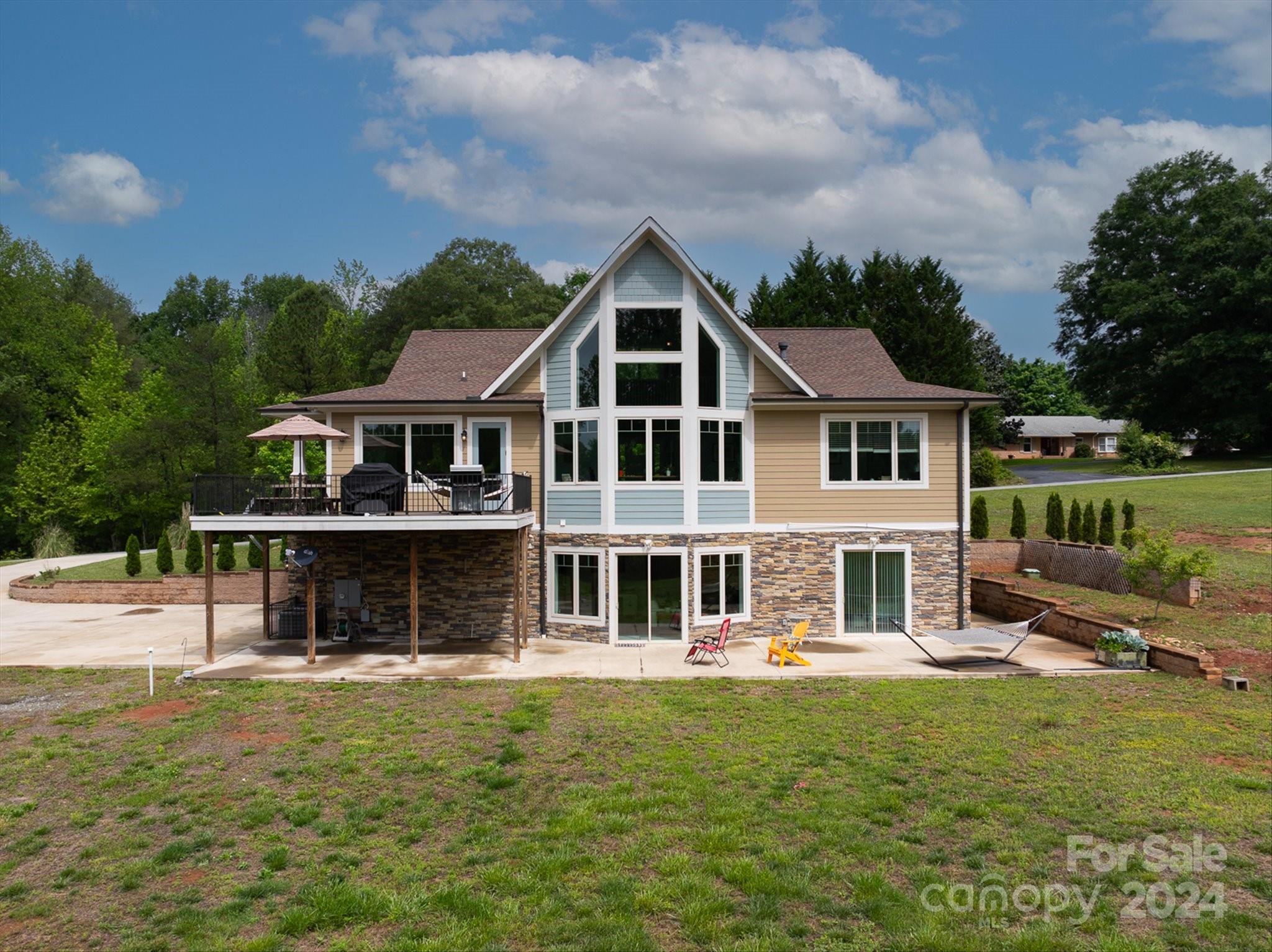 464 Hooper Creek Road Tryon, NC 28782 - Photo 2 of 24 a front view of a house with a yard table and chairs