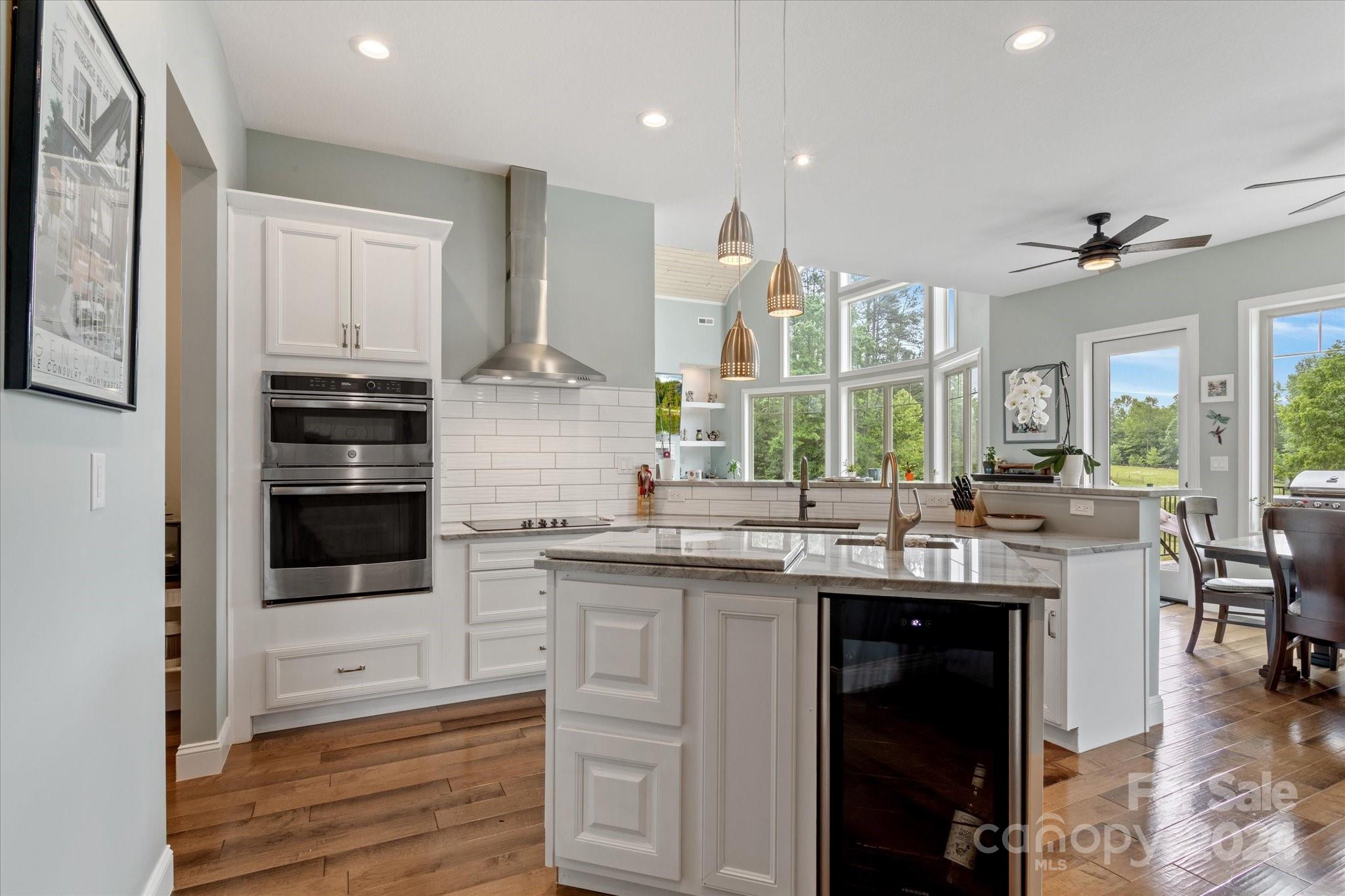 464 Hooper Creek Road Tryon, NC 28782 - Photo 8 of 24 a kitchen with kitchen island granite countertop a stove and a sink
