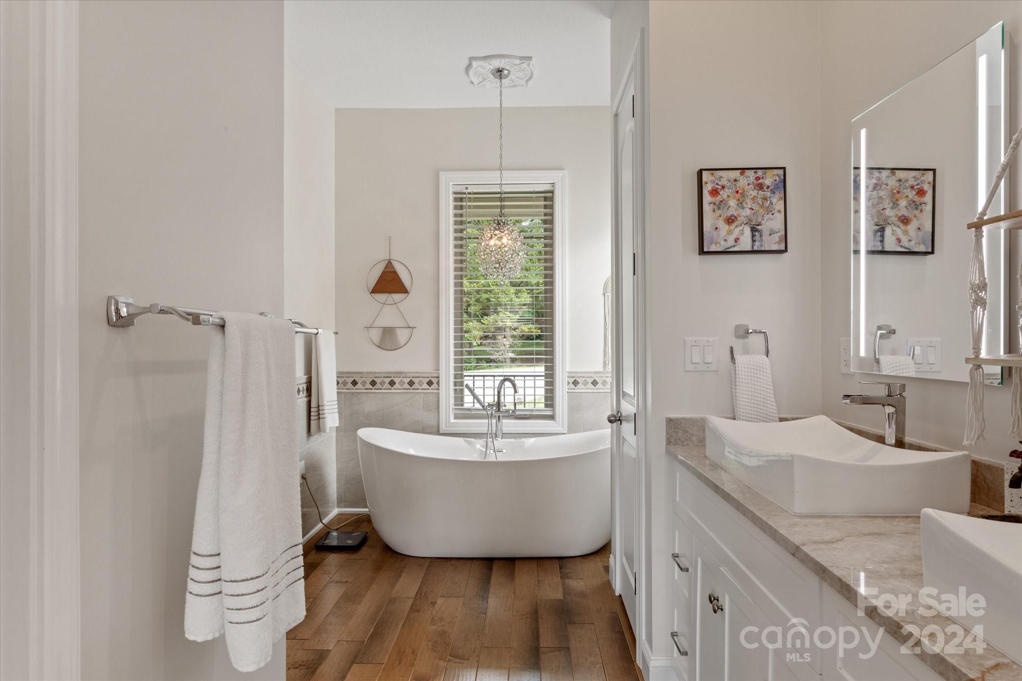 464 Hooper Creek Road Tryon, NC 28782 - Photo 10 of 24 a spacious bathroom with a bathtub sink and mirror