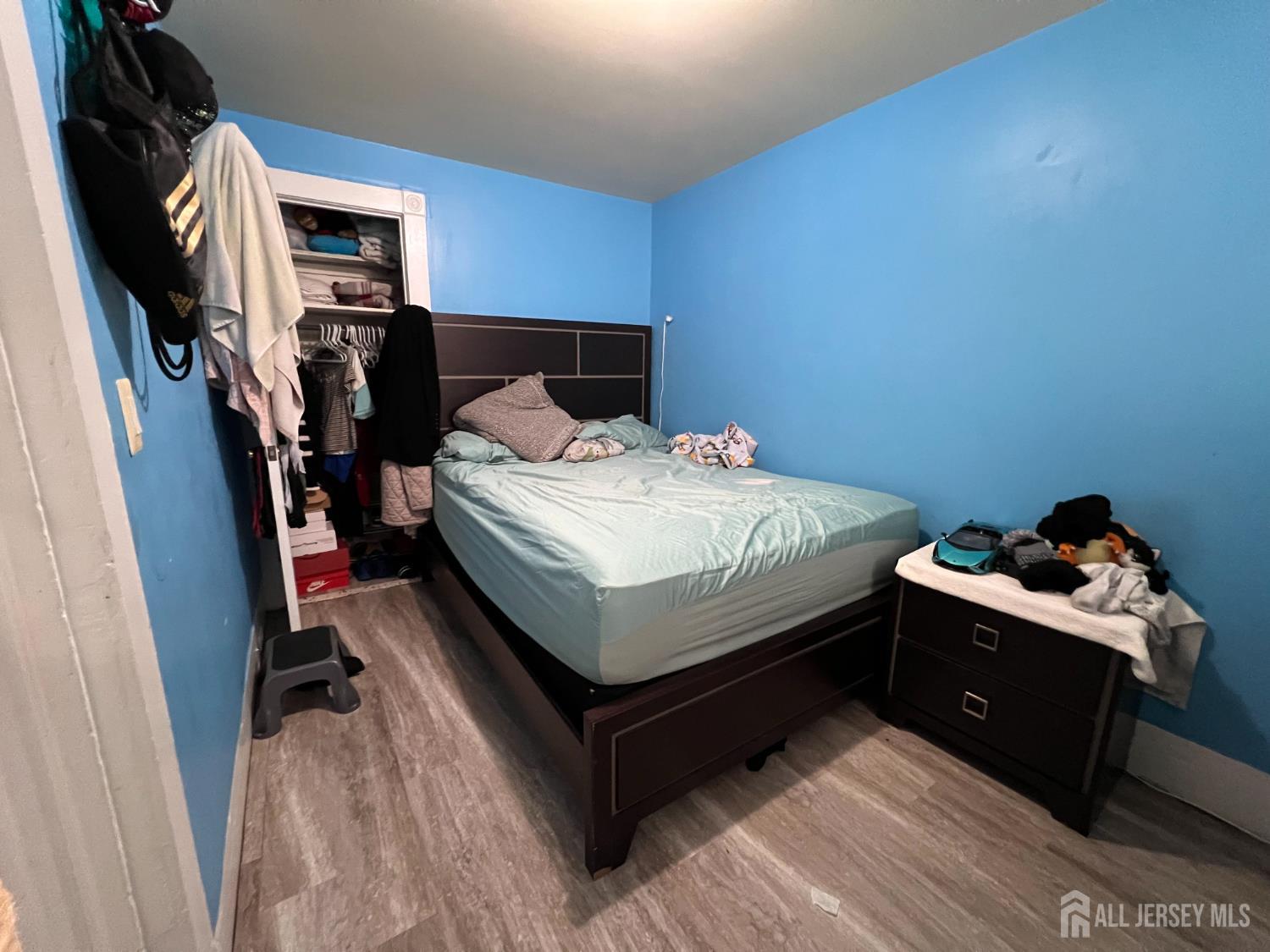 109 Washington Street, Unit 2 Perth Amboy, NJ 08861 - Photo 11 of 12 a bed sitting in a bedroom next to a window