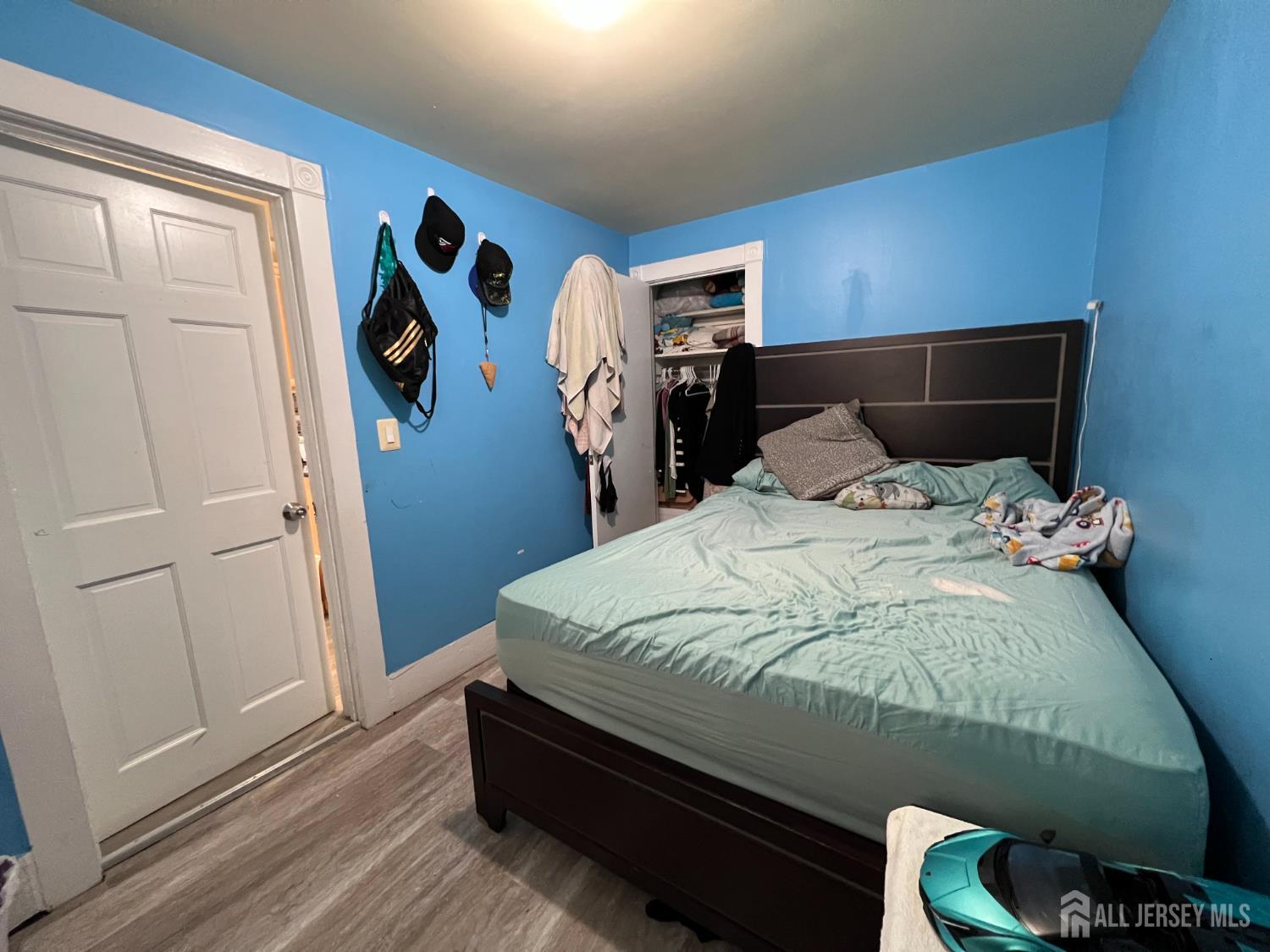 109 Washington Street, Unit 2 Perth Amboy, NJ 08861 - Photo 12 of 12 a bed sitting in a bedroom next to a window