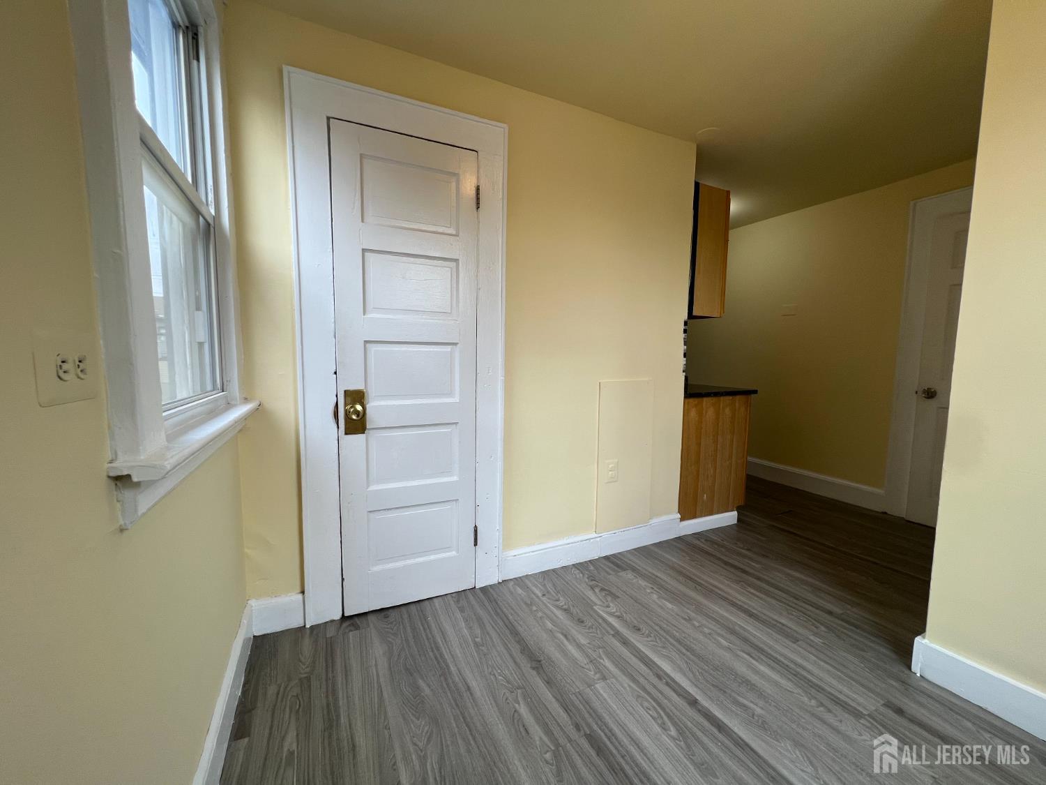 109 Washington Street, Unit 2 Perth Amboy, NJ 08861 - Photo 9 of 15 an empty room with wooden floor and closet
