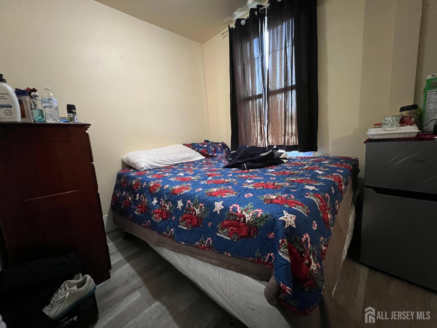 109 Washington Street, Unit 2 Perth Amboy, NJ 08861 - Photo 10 of 12 a bedroom with a bed and a window