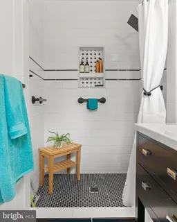 a bathroom with a sink a toilet and a shower curtain