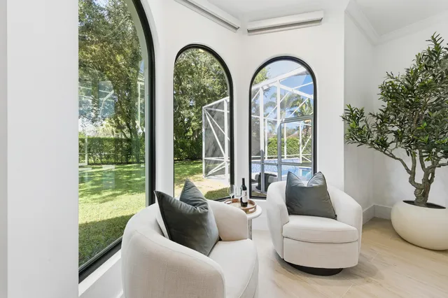 a view of a kitchen with fridge and wooden floor