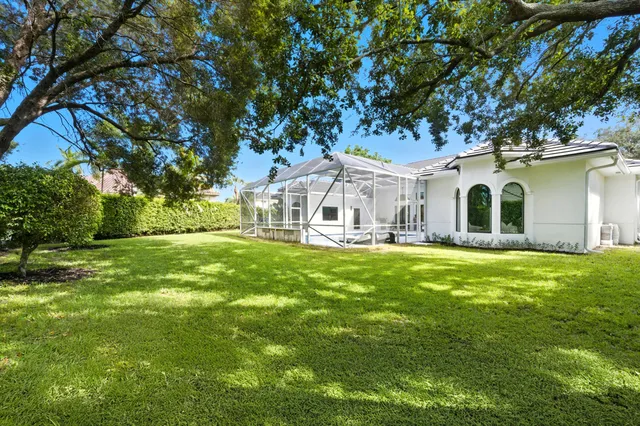 an aerial view of residential houses with outdoor space and river