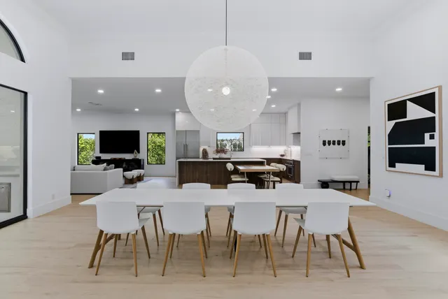 a large kitchen with a table and chairs in it