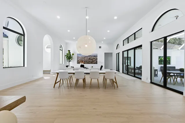 a kitchen with kitchen island stainless steel appliances a sink and a refrigerator