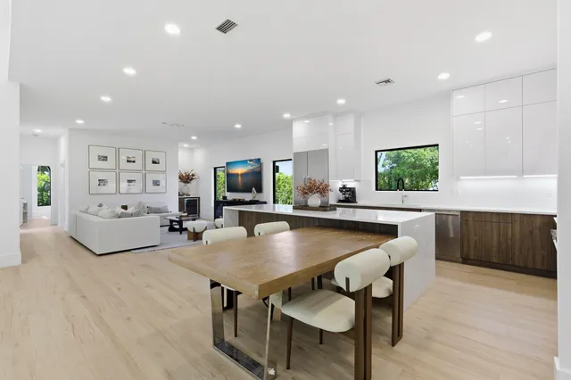 a kitchen with stainless steel appliances kitchen island granite countertop a sink and cabinets