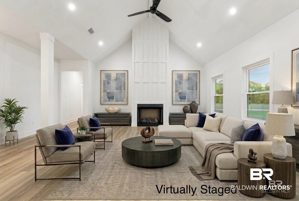 28310 Comstock Road Elberta, AL 36530 - Photo 3 of 60 Virtually Staged - Expansive living area featuring a vaulted ceiling and wood-finish flooring