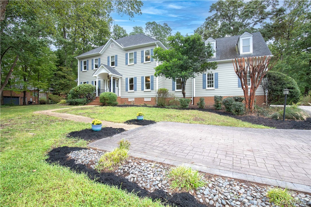 a front view of a house with a yard and porch