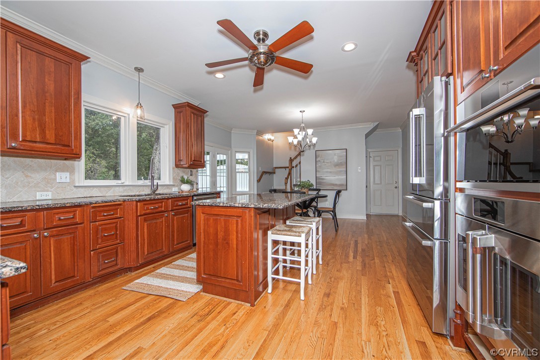 2425 Hartlepool Lane Midlothian, VA 23113 - Photo 15 of 44 a dining hall with stainless steel appliances granite countertop a stove a sink dishwasher and a cabinets with wooden floor