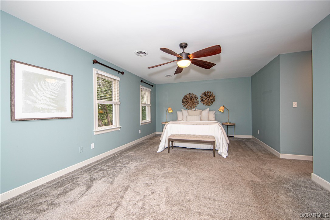 2425 Hartlepool Lane Midlothian, VA 23113 - Photo 20 of 44 a bedroom with a bed and a chandelier