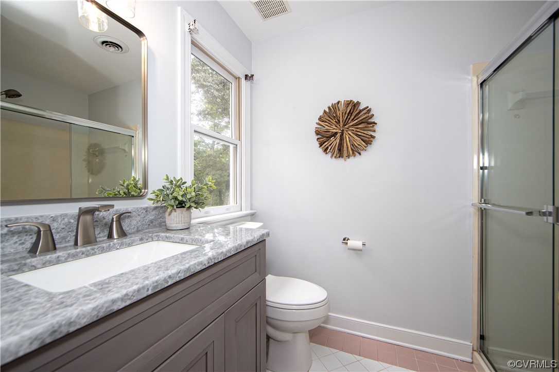 2425 Hartlepool Lane Midlothian, VA 23113 - Photo 24 of 44 a bathroom with a granite countertop sink a large mirror a toilet and a window