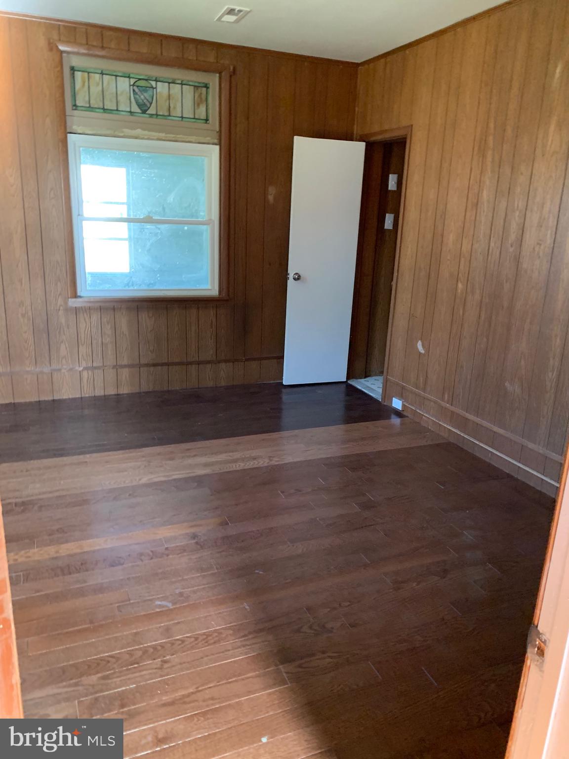 4101 Marx Avenue Baltimore, MD 21206 - Photo 13 of 42 an empty room with wooden floor and windows