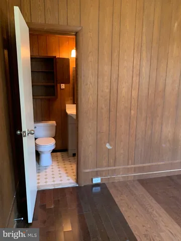 a view of a room with door and wooden walls