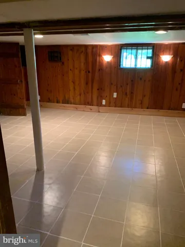 a view of an empty room with windows and cabinet