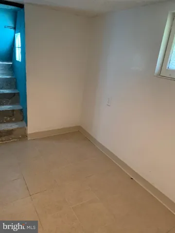 a view of an empty room with a fireplace