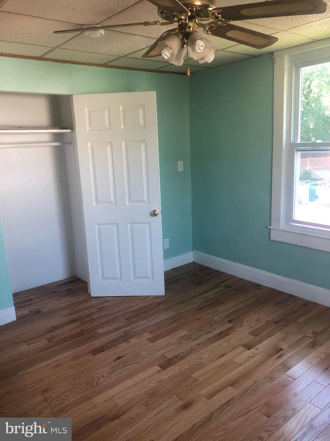4101 Marx Avenue Baltimore, MD 21206 - Photo 31 of 42 an empty room with wooden floor fan and windows