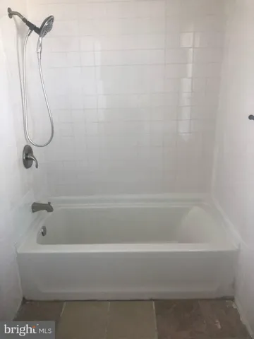 en empty room with wooden floor and windows