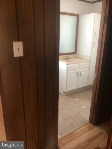 a white toilet sitting next to a bathroom sink