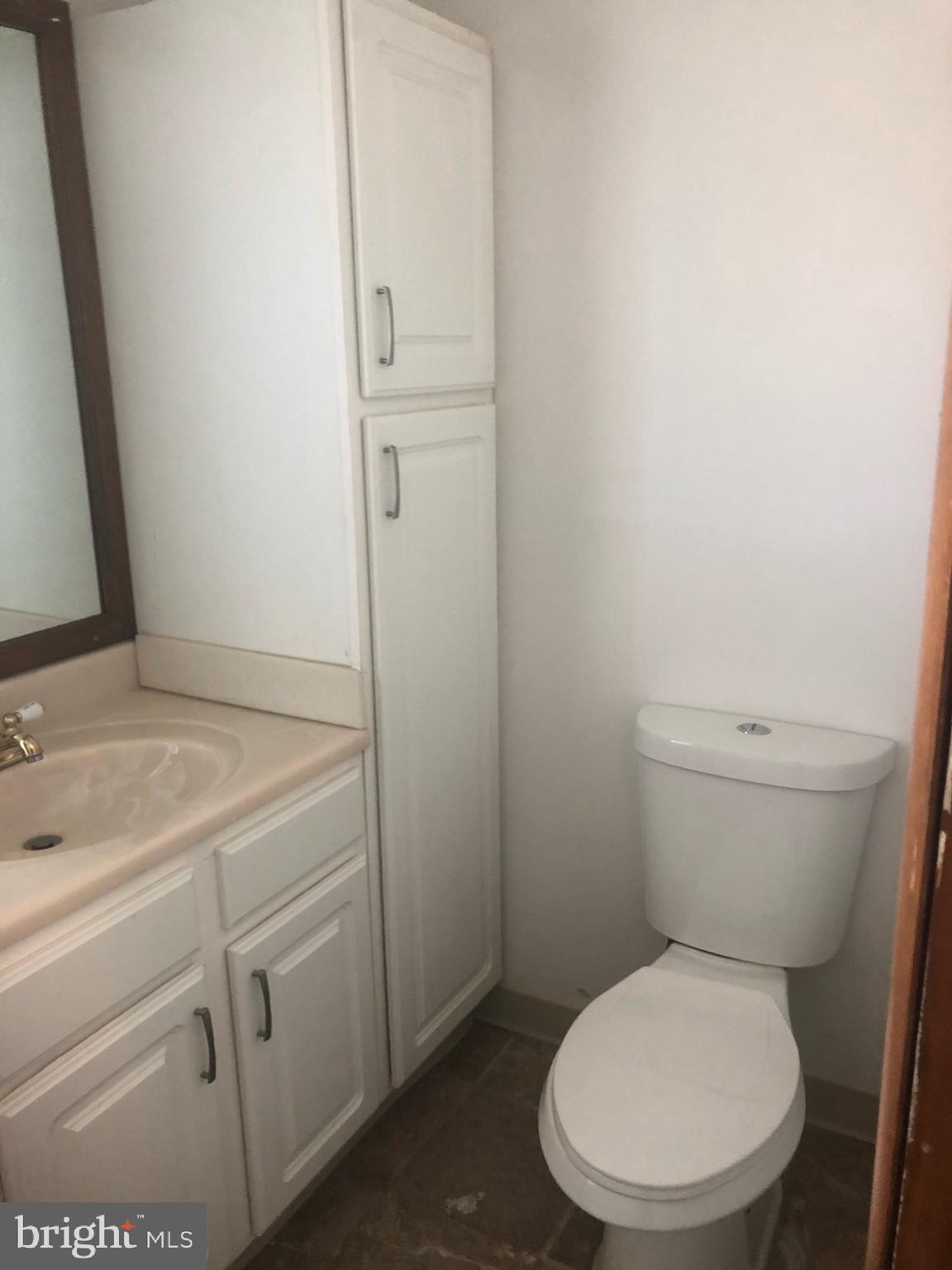 4101 Marx Avenue Baltimore, MD 21206 - Photo 42 of 42 a white toilet sitting next to a bathroom sink