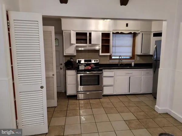 a kitchen with stainless steel appliances a stove sink and microwave
