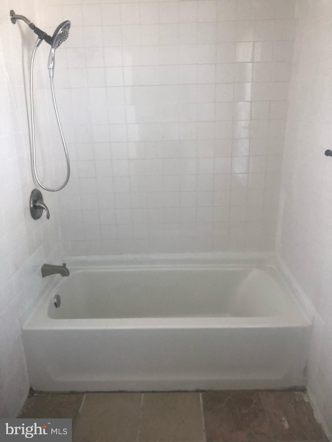 4101 Marx Avenue Baltimore, MD 21206 - Photo 9 of 19 a bathroom with a bath tub with a shower