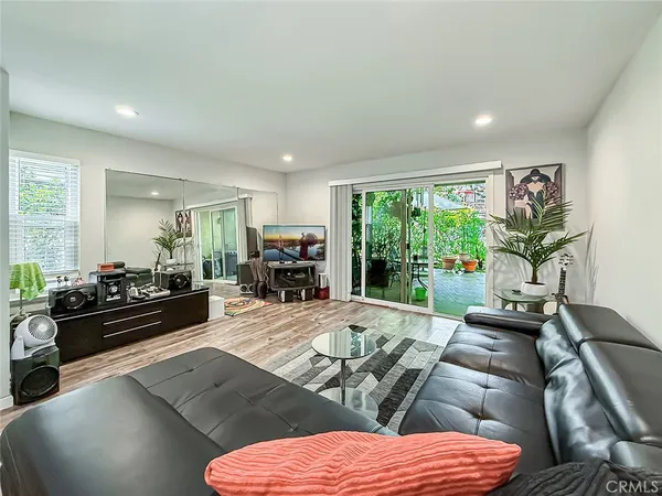 a large bedroom with furniture and a large window