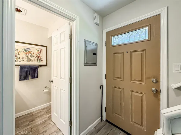 a view of a hallway with wooden floor and closet area