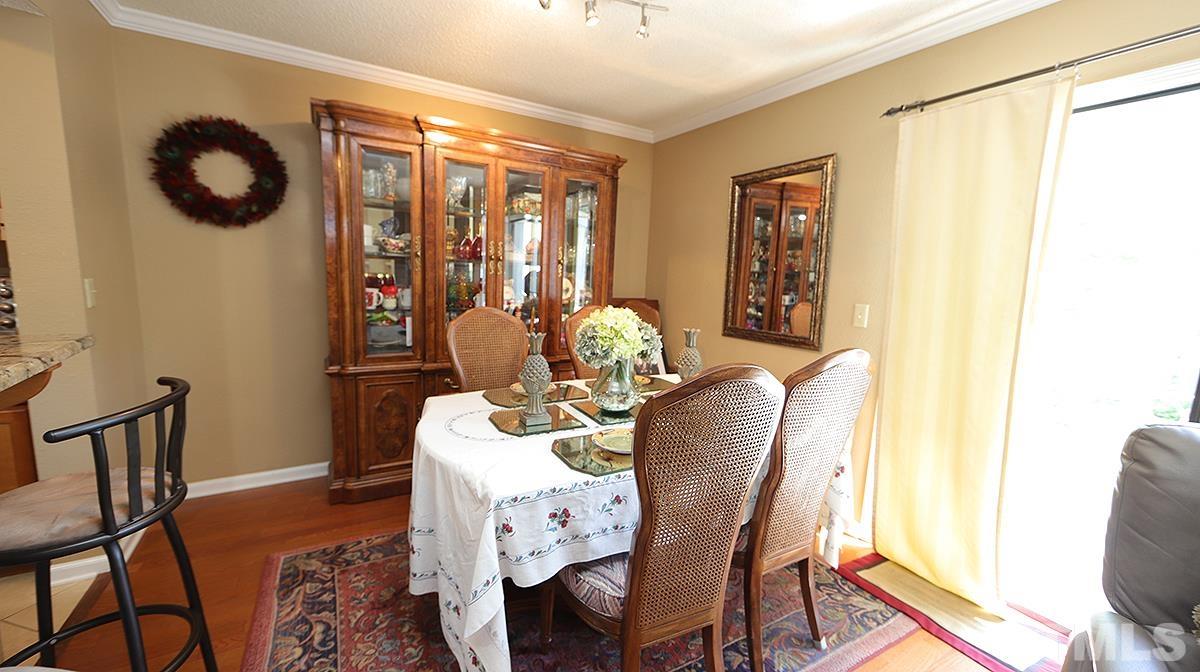 7902 Falcon Rest Circle, Unit 7902 Raleigh, NC 27615 - Photo 5 of 13 a view of a dining room with furniture and chandelier