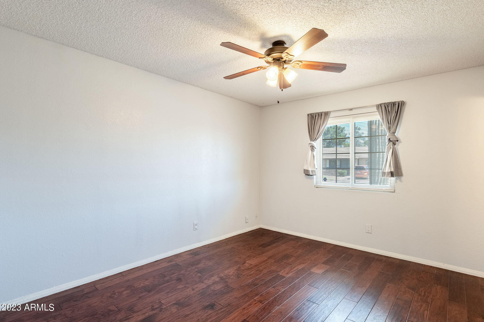964 West Hackamore Street Mesa, AZ 85201 - Photo 13 of 24 an empty room with wooden floor fan and windows
