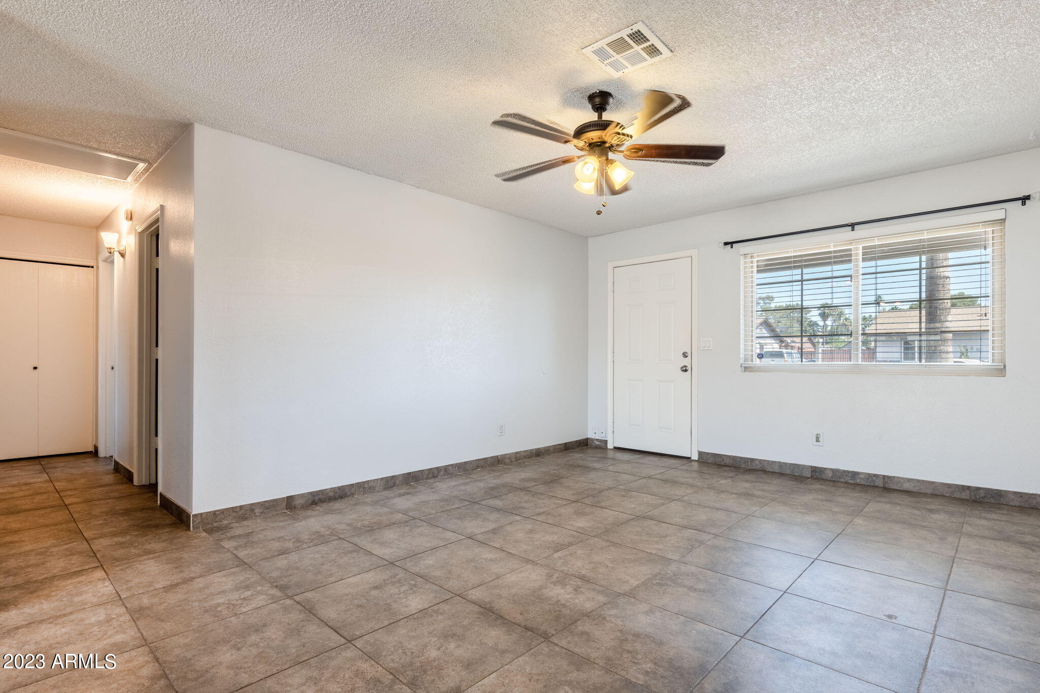 964 West Hackamore Street Mesa, AZ 85201 - Photo 6 of 24 an empty room with windows and fan